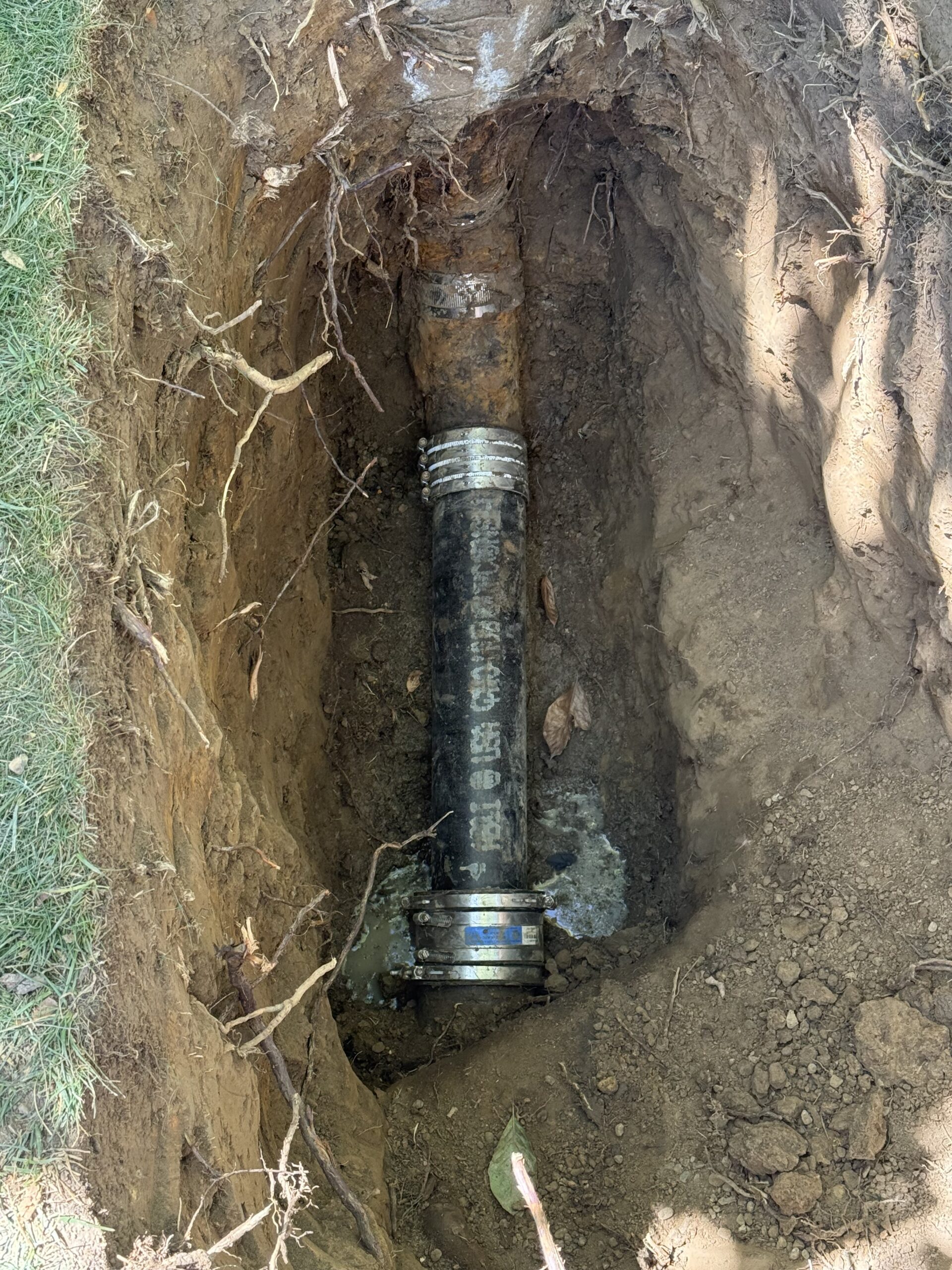 Exposed cast iron sewer pipe during sewer line inspection and replacement